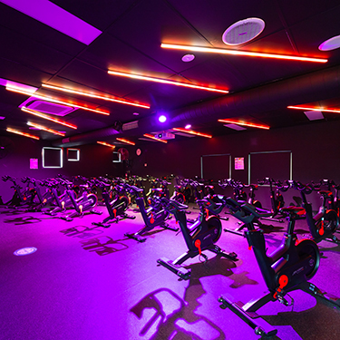Image of the spin room at Collingwood Leisure Centre with iC7 spin bikes and feature lighting in the room
