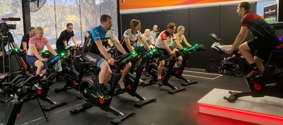 Instructors all on a bike undergoing training of the new spin bikes