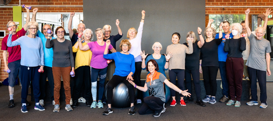 Move for Life class participants pose as a group