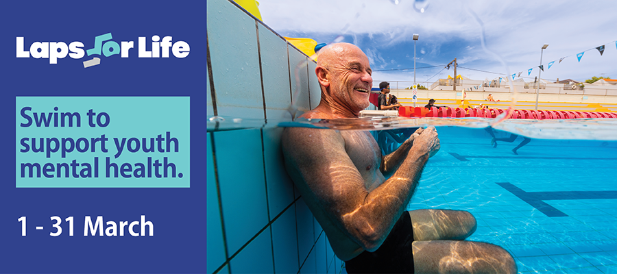 Image of person smiling, in the water and leaning against the end of a pool lane at Fitzroy Swimming Pool. Image contains the Laps for Life logo and text 'Swim to support youth mental health'.