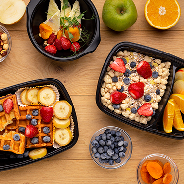 An image taken from overhead of different breakfast items in containers