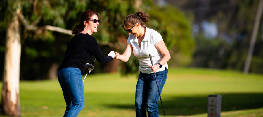 Two women on the green laughing together