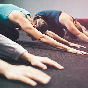 People in a room doing yoga