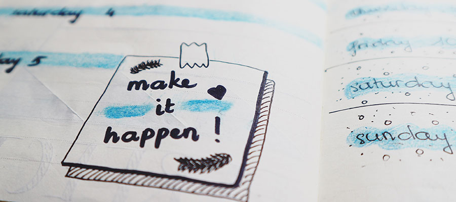 A page of someones diary with writing saying make it happen and some dates listed