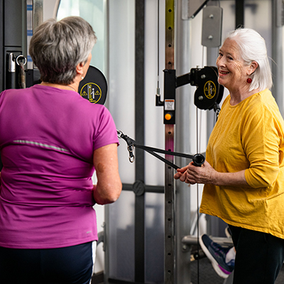 Image of two women exercising and talking in the gym at Collingwood Leisure Centre