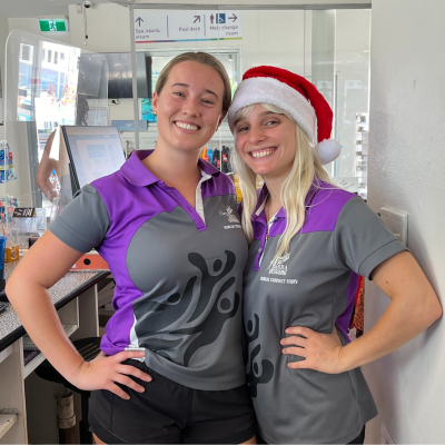 Two Yarra Leisure customer service officers at reception one with a santa hat