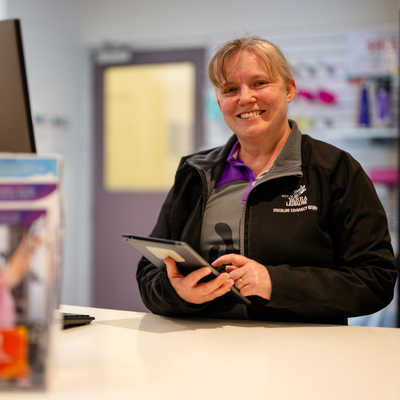 Female customer service officer at leisure centre front reception 