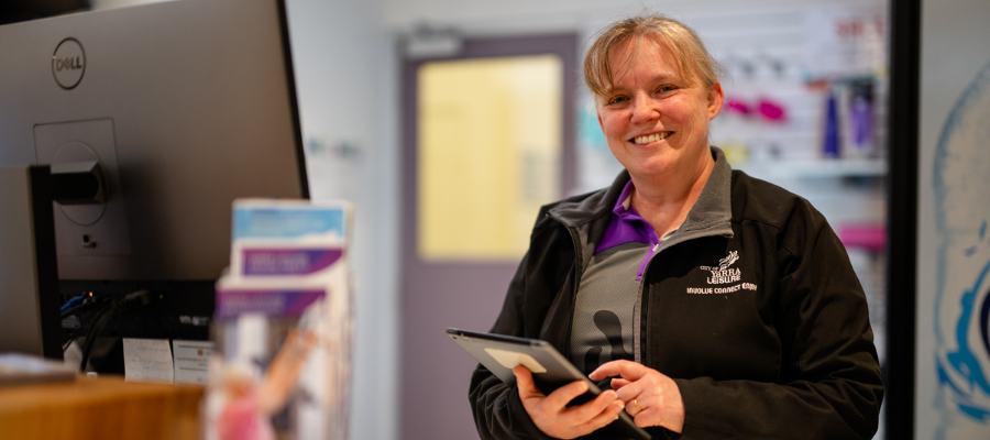 Female customer service officer at leisure centre front reception 