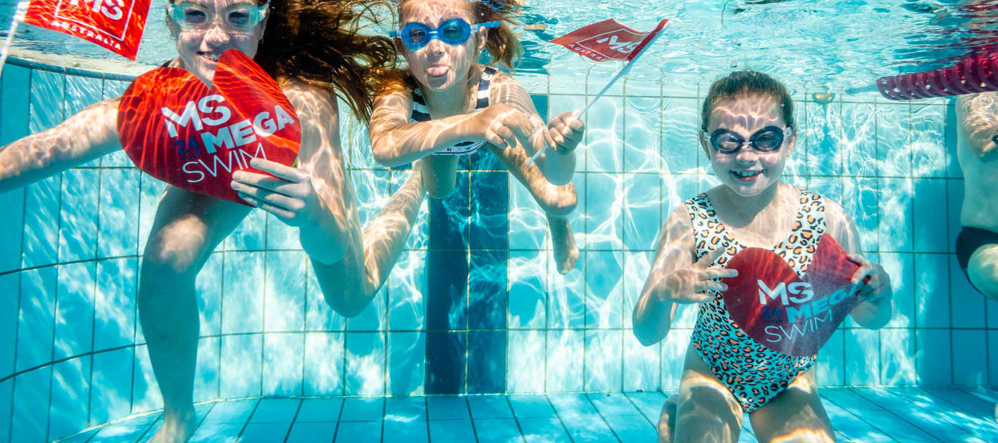 Three girls under the water smiling