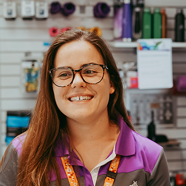 A Yarra Leisure customer service officer smiling at the customer service desk