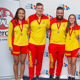 Four lifeguards on stage during the lifeguard challenge award presentations