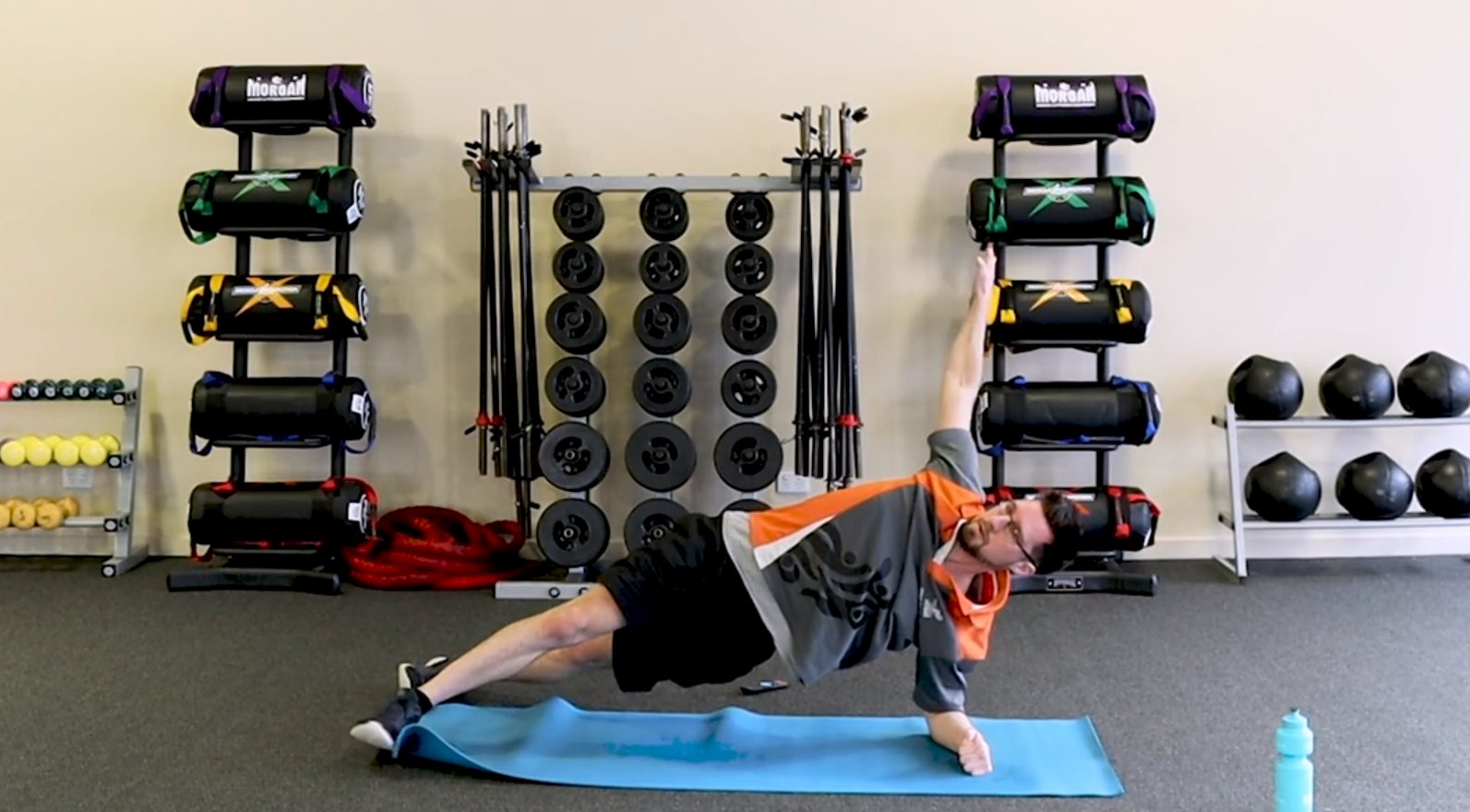 Gym Instructor Adam holding a side plank