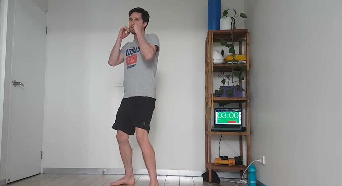 Gym Instructor Adam holding a boxing stance in his house