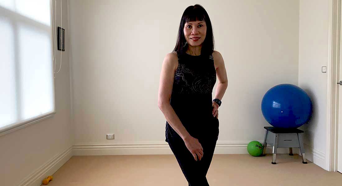 Gym Instructor Sharon standing in her home in active wear smiling