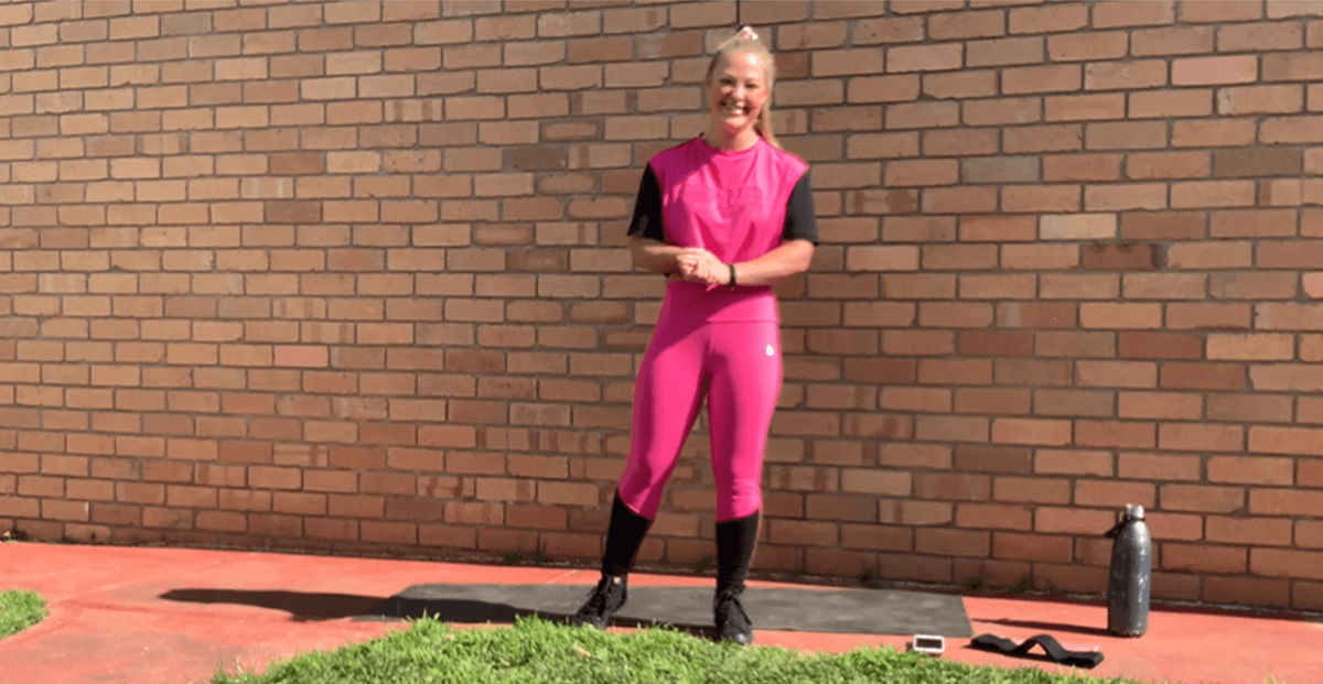 Gym Instructor Mel standing outside in her activewear smiling