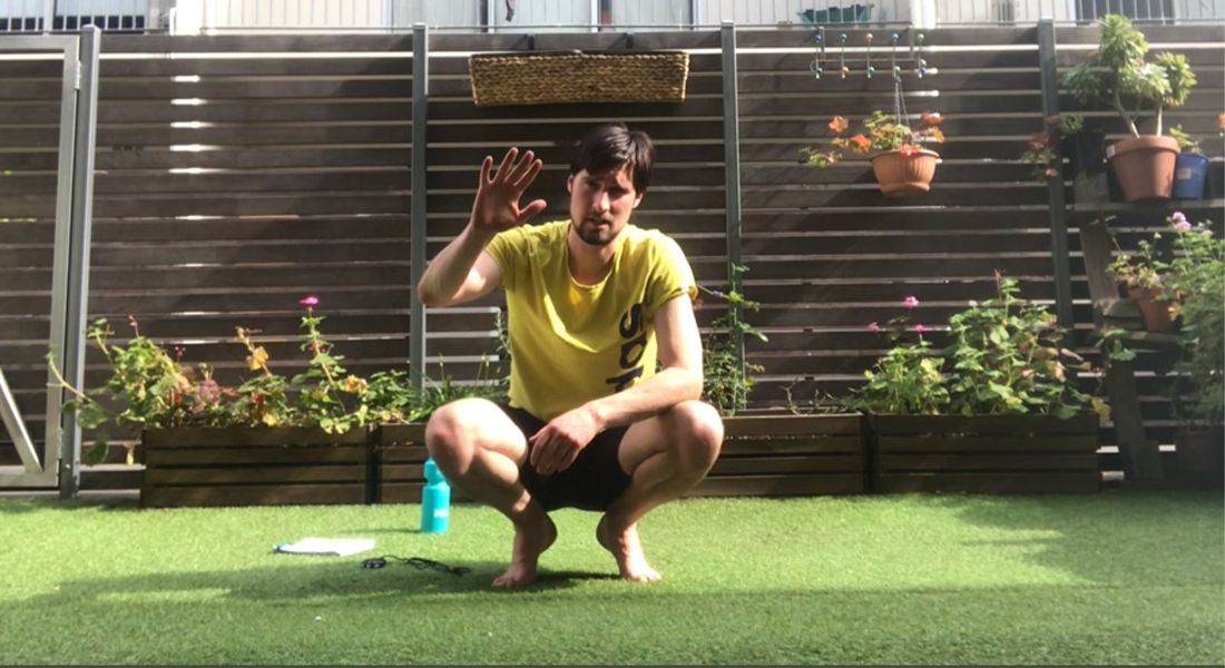 Gym Instructor Adam in his backyard in his active wear and waving