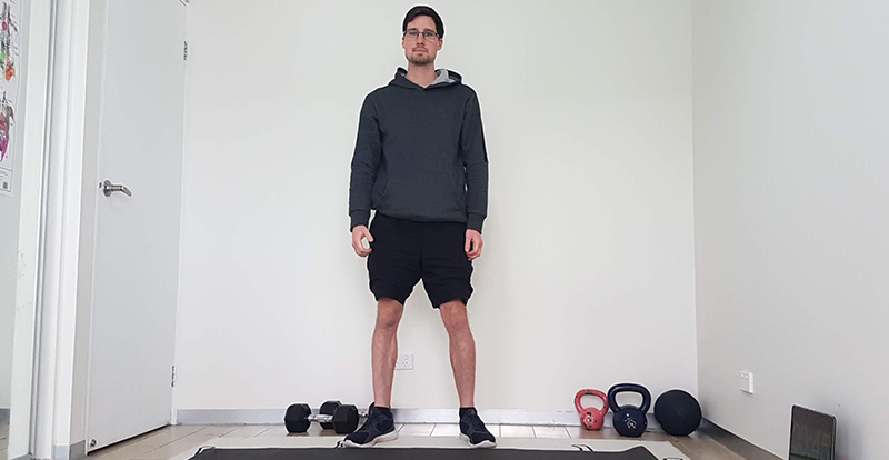 Gym Instructor Adam standing in a room at home ready to do a workout
