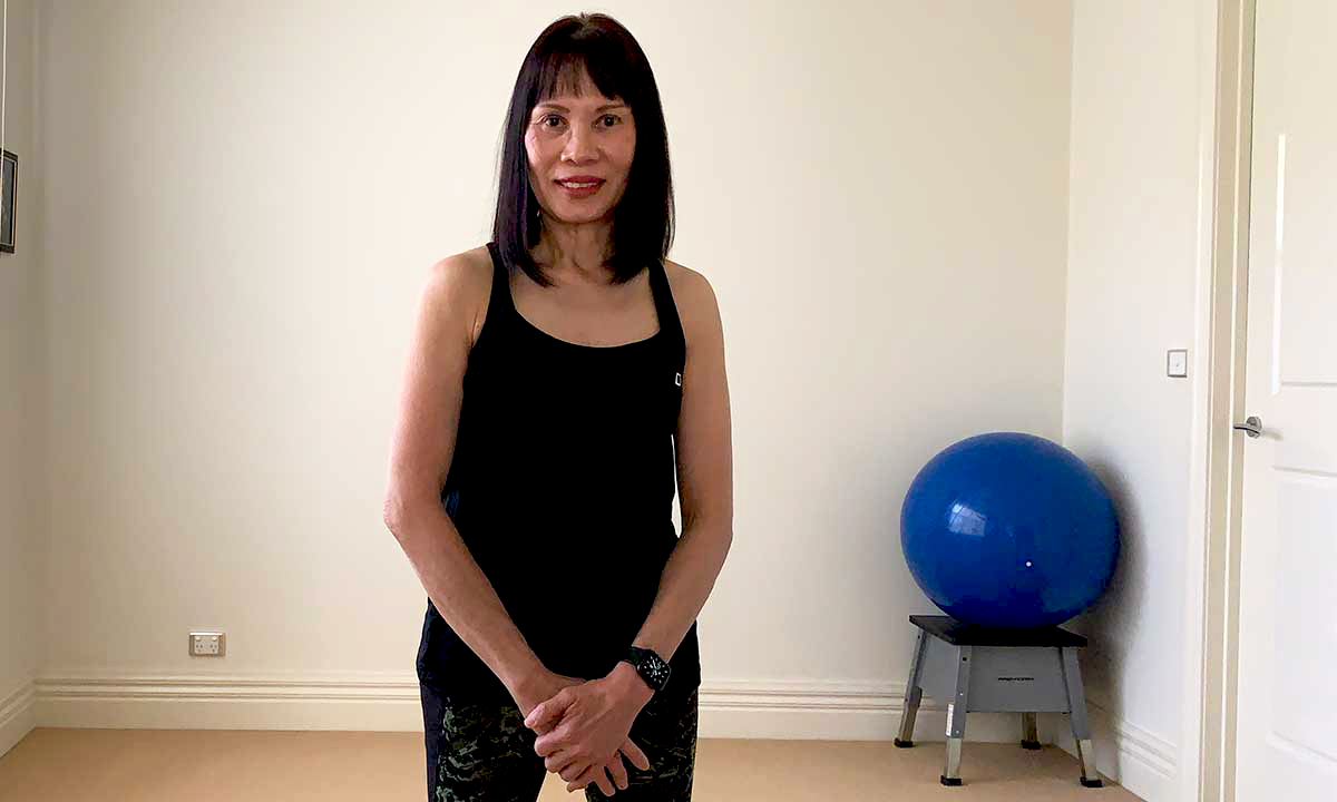 Gym Instructor Sharon standing in her active wear at home smiling