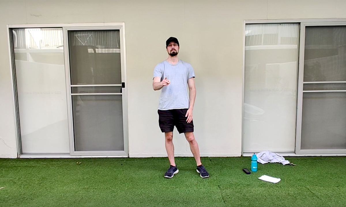 Gym Instructor Adam standing in his backyard and pointing at the camera