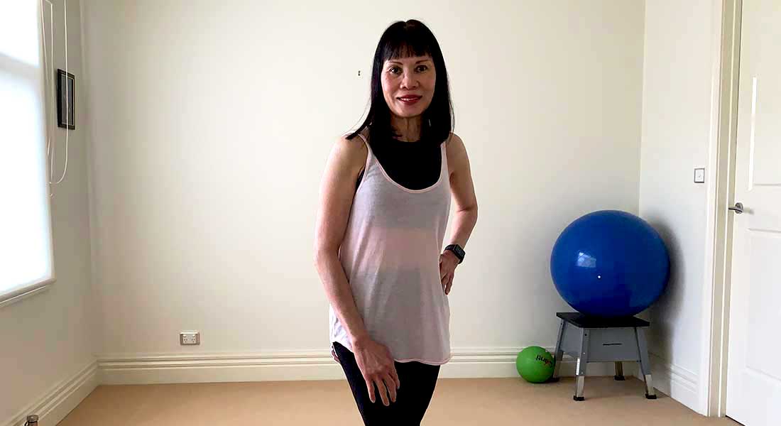 Gym Instructor Sharon standing in her home in active wear smiling