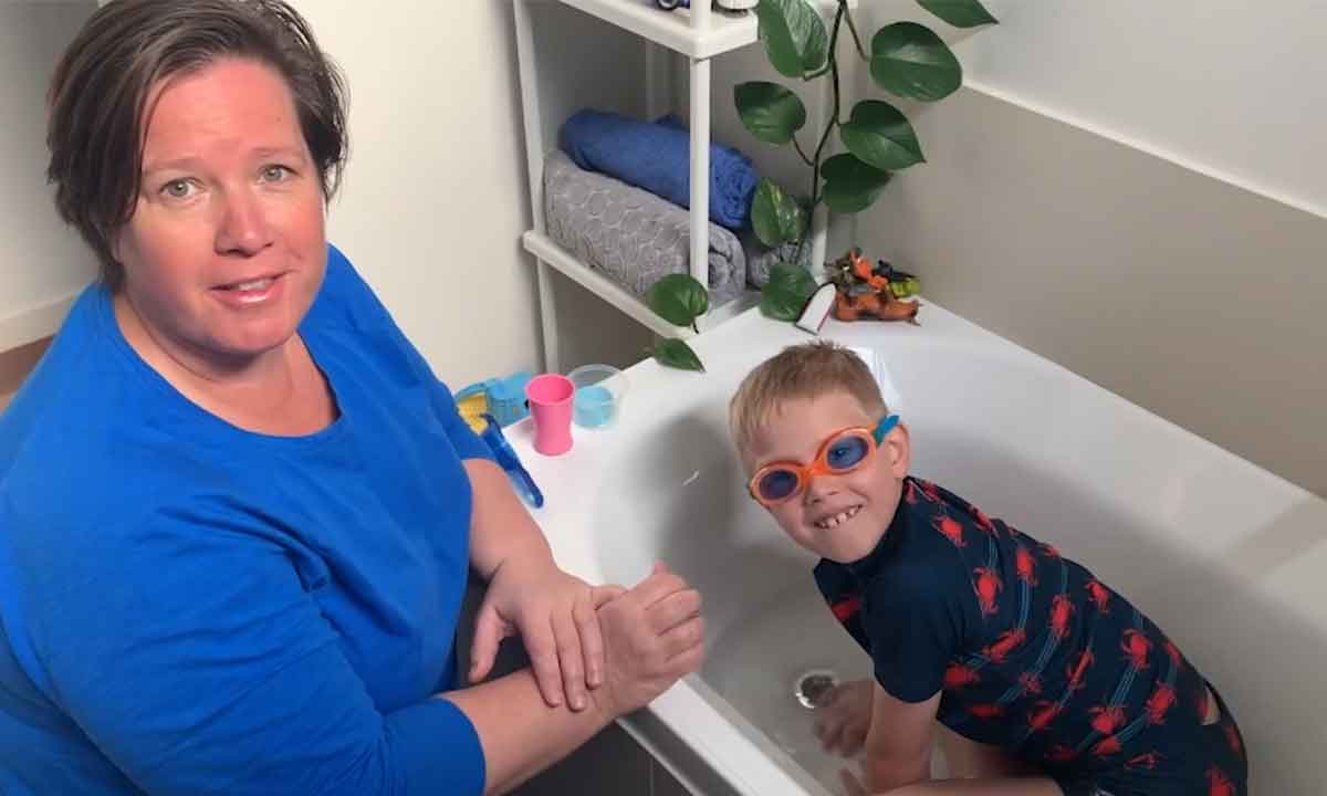 Swim Instructor Anna with her son in the bath smiling